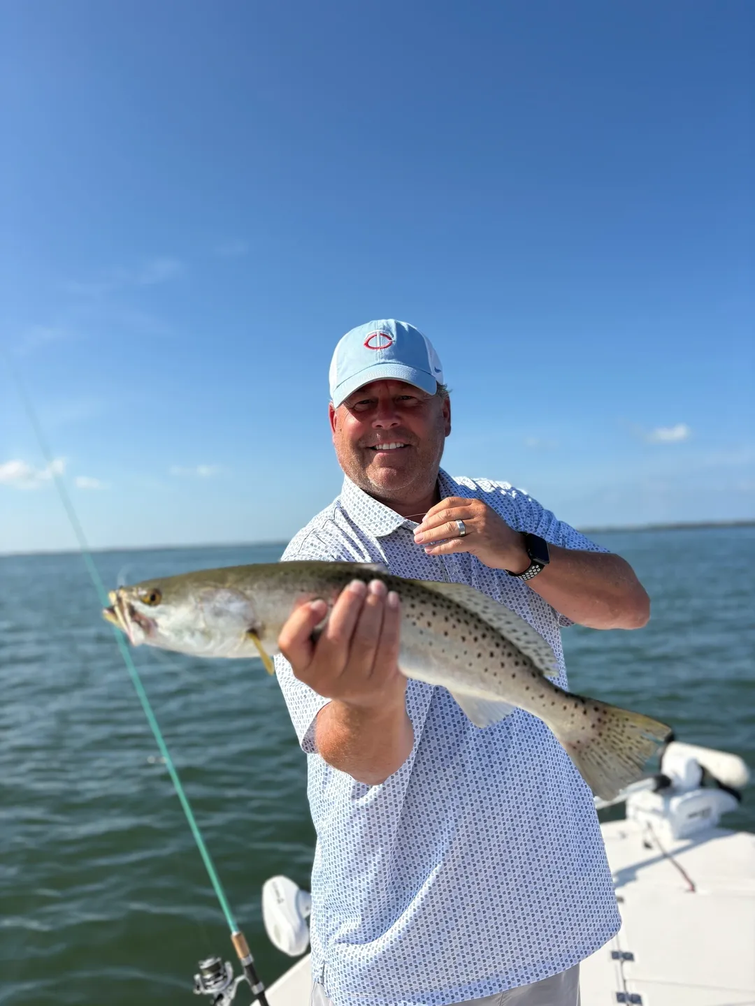 Smiling angler with freshly caught fish