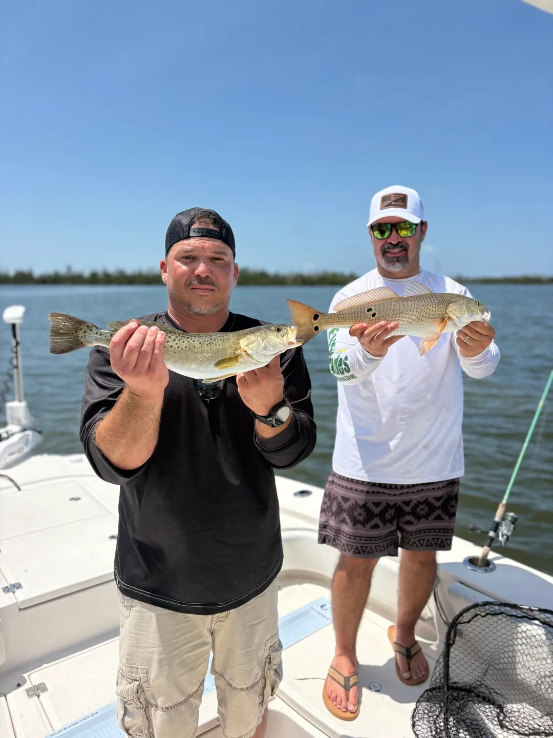 Fishermen displaying their catch on a boat