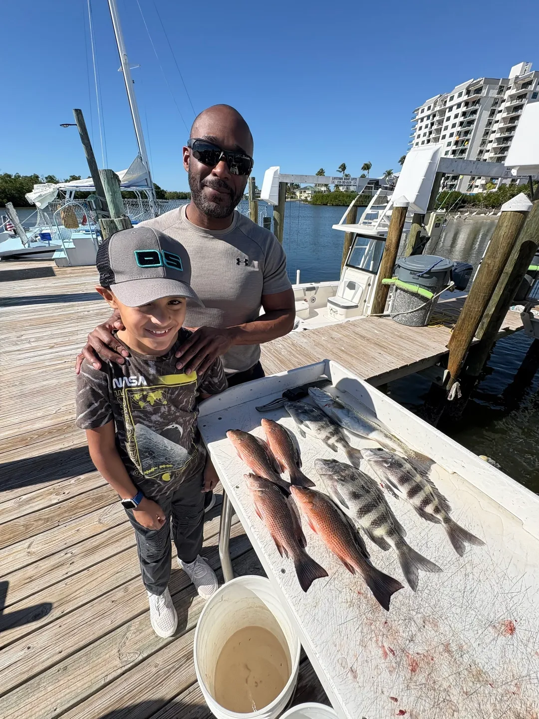 Smiling duo displaying their fish haul