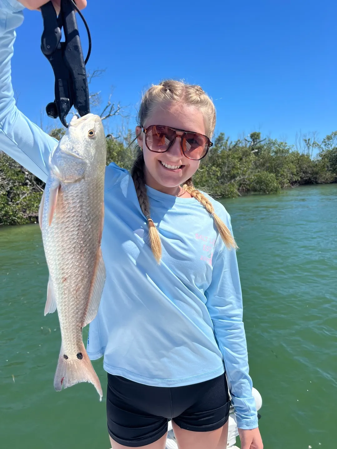 Smiling girl with a fish catch