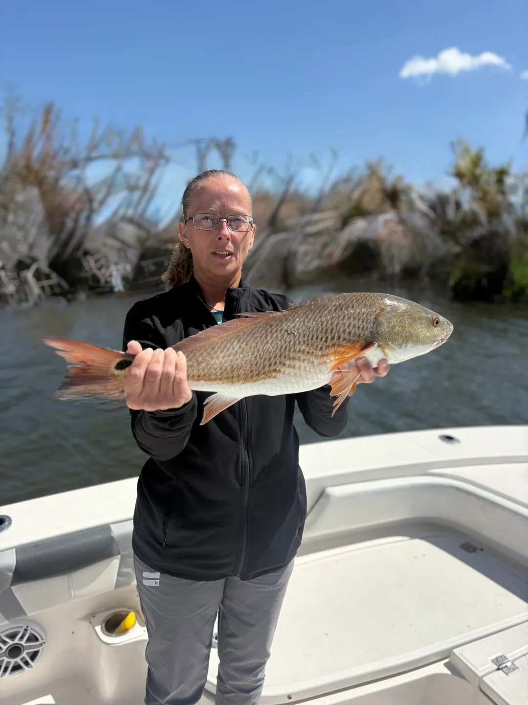 Angler with impressive fish outdoors