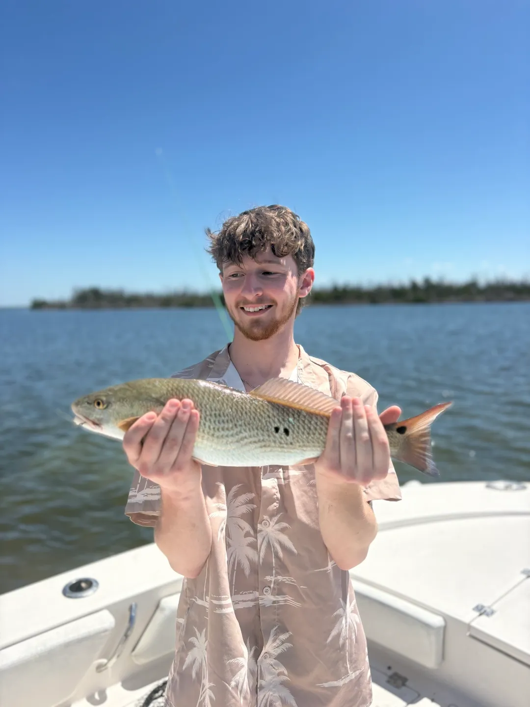 Man proudly displays his catch.