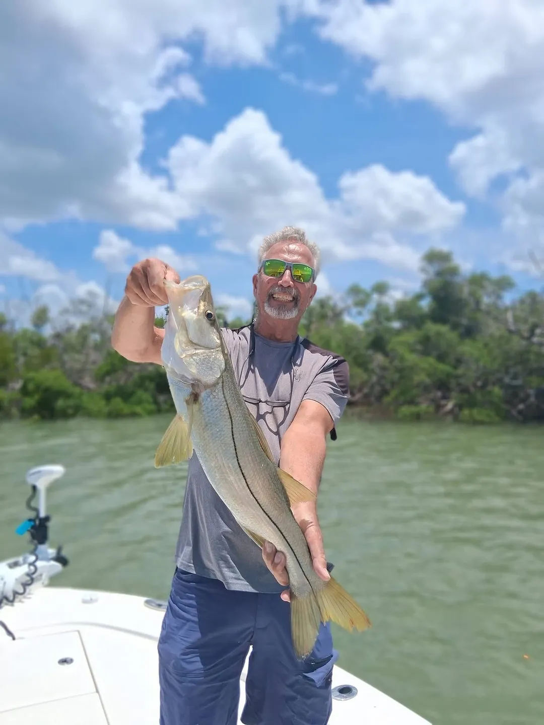 Smiling man with large fish in hand