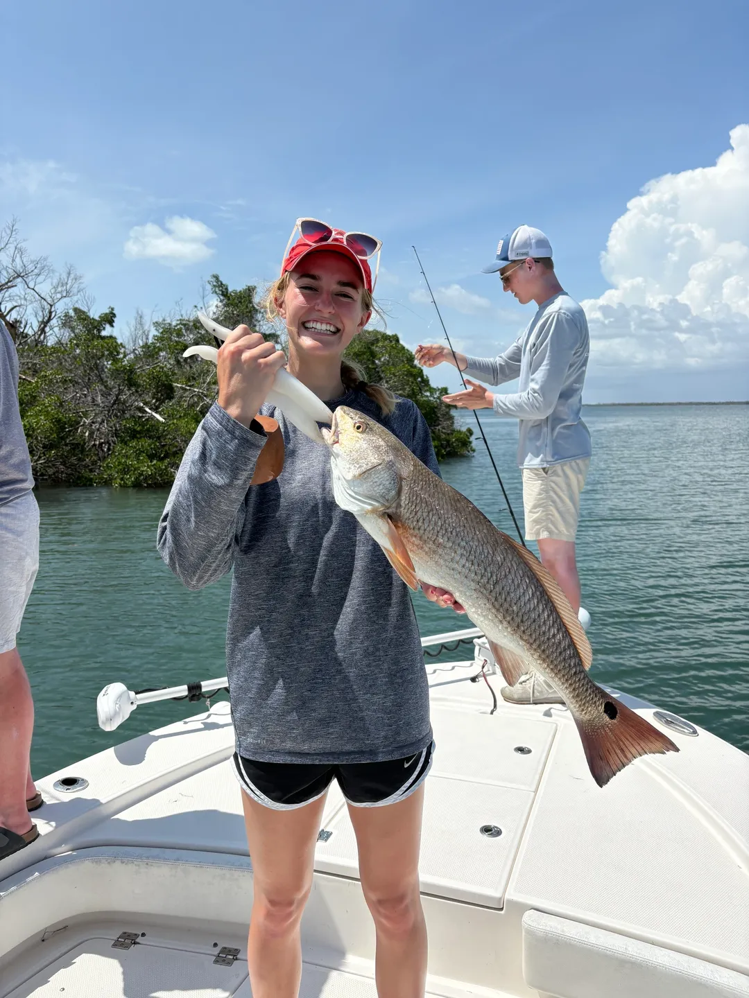 Smiling angler with freshly caught fish