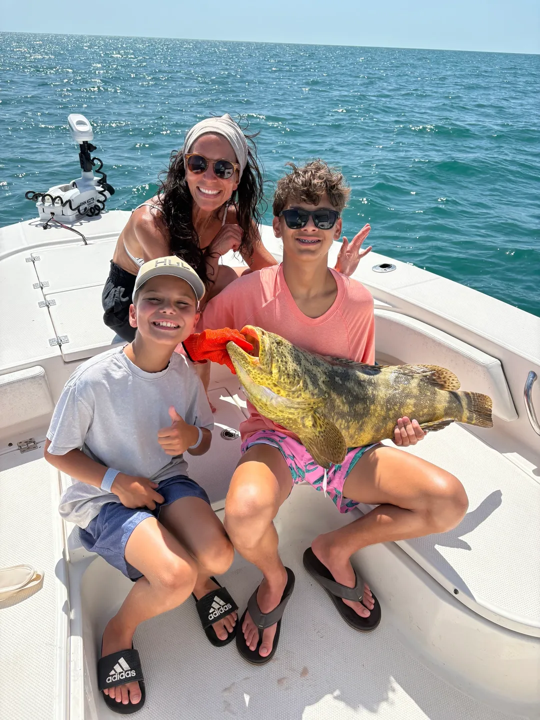 Happy group holding a large fish