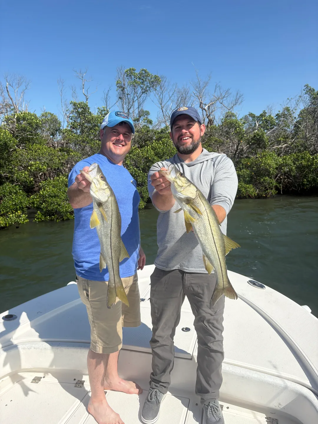 Friends fishing with snook catch