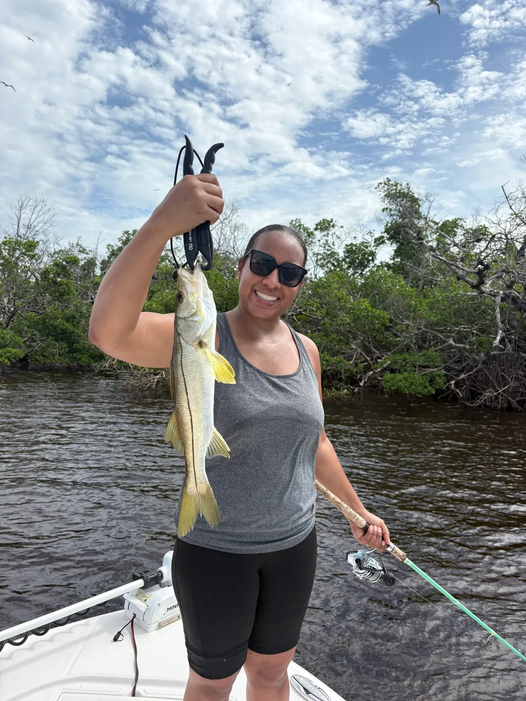 Smiling angler with her catch