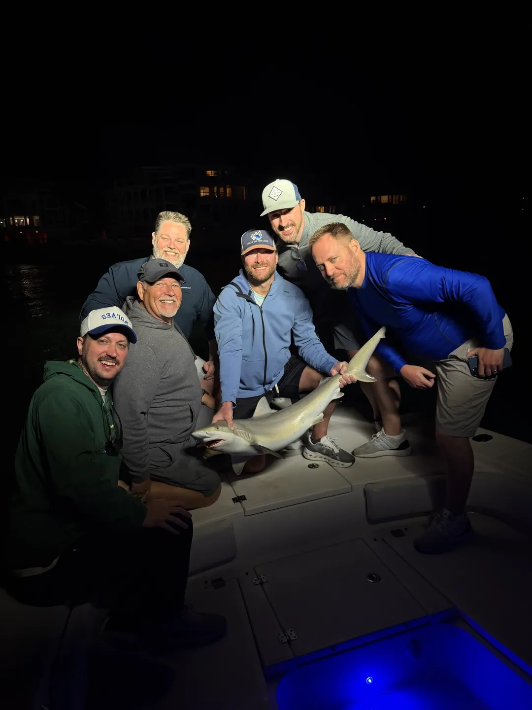 Smiling group with catch at night