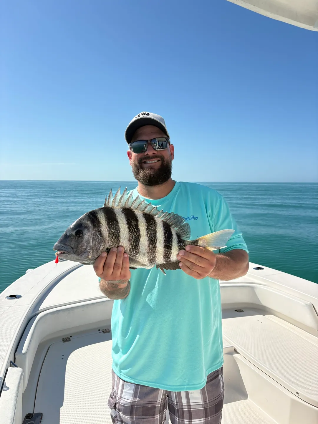 Man holding a fish on a boat