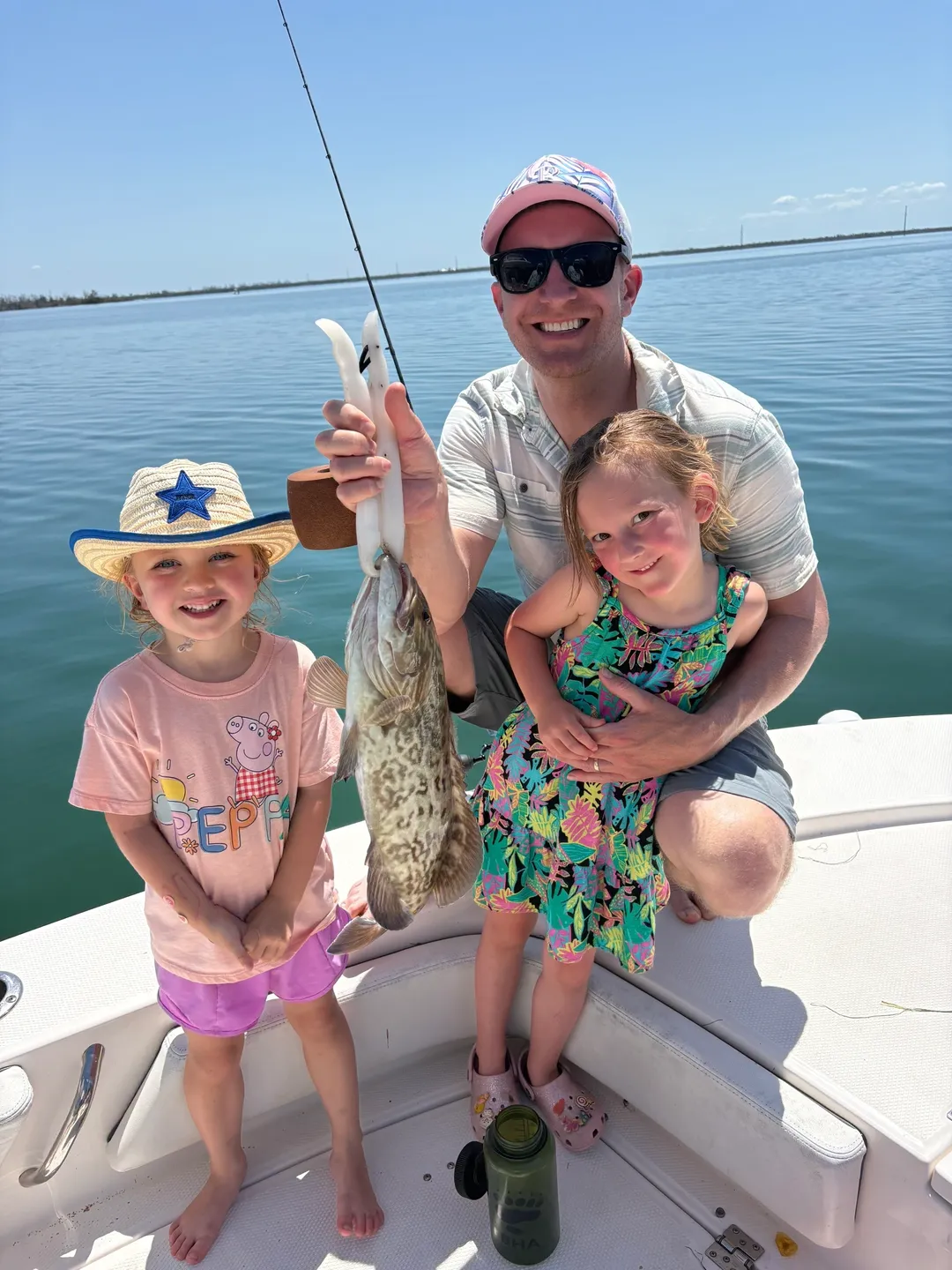 Father and daughters on a boat