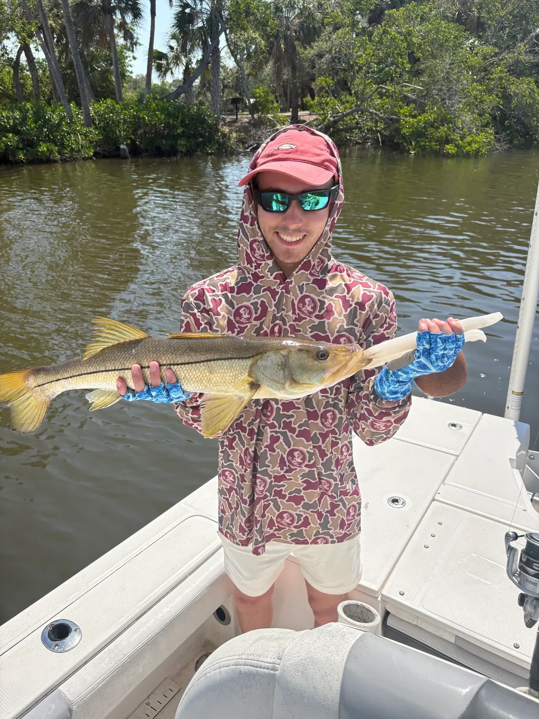 Person holding large fish on boat