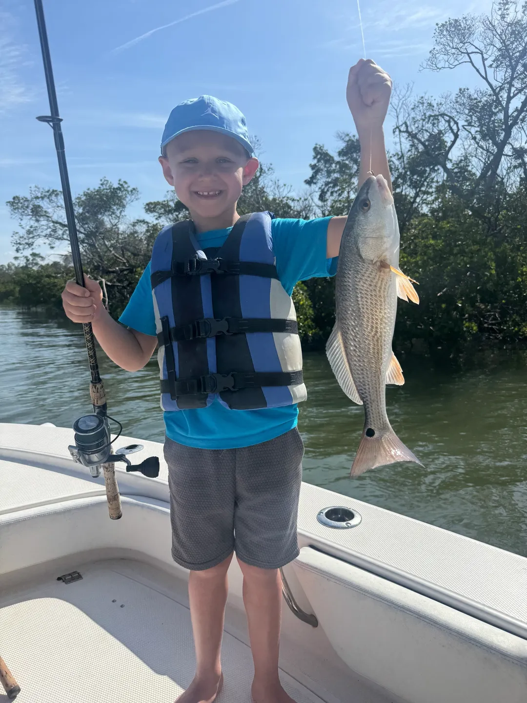 Young boy catches fish