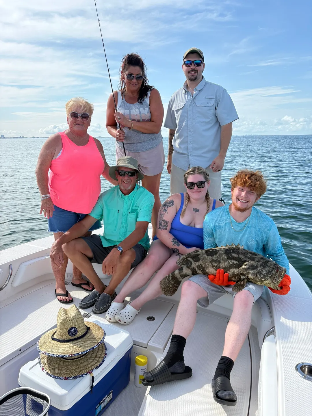 Family with fish catch on sunny day