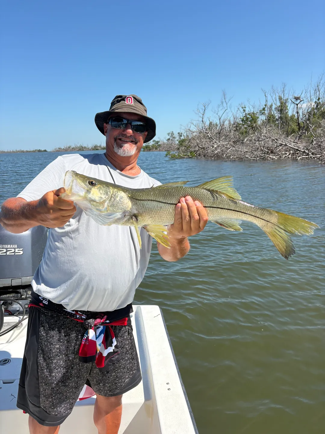 Smiling angler with snook catch
