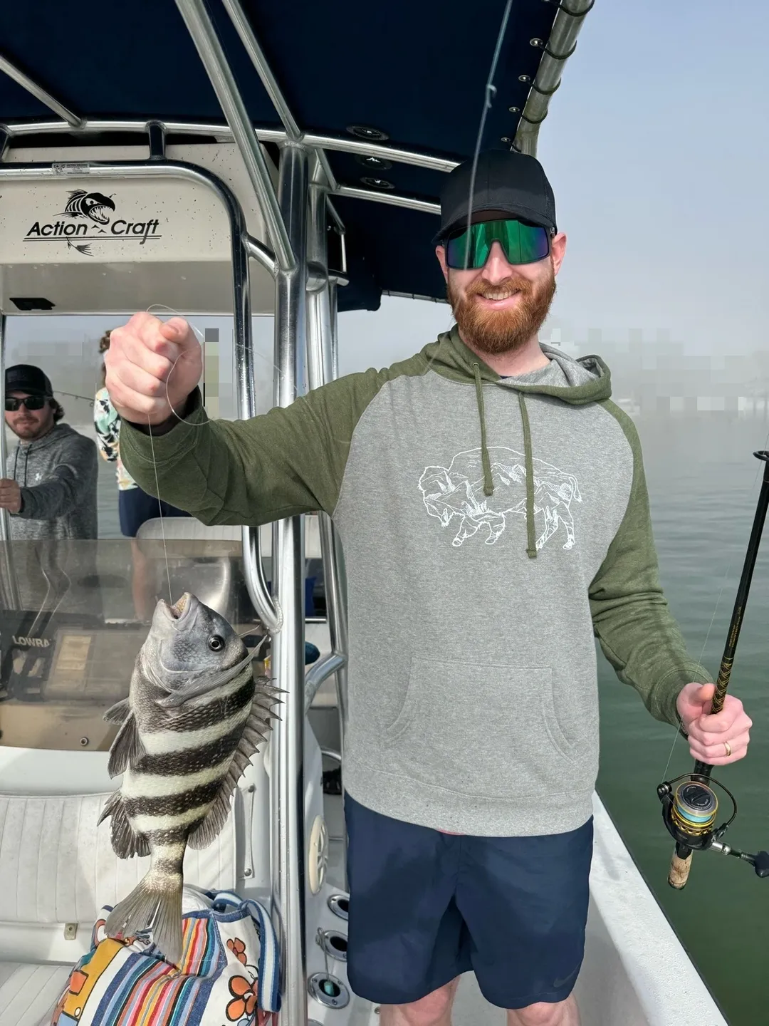 Man holding a fish on a boat